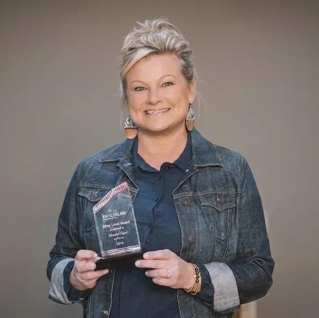 Christa Tippit holding a Keller Williams Silver Level award